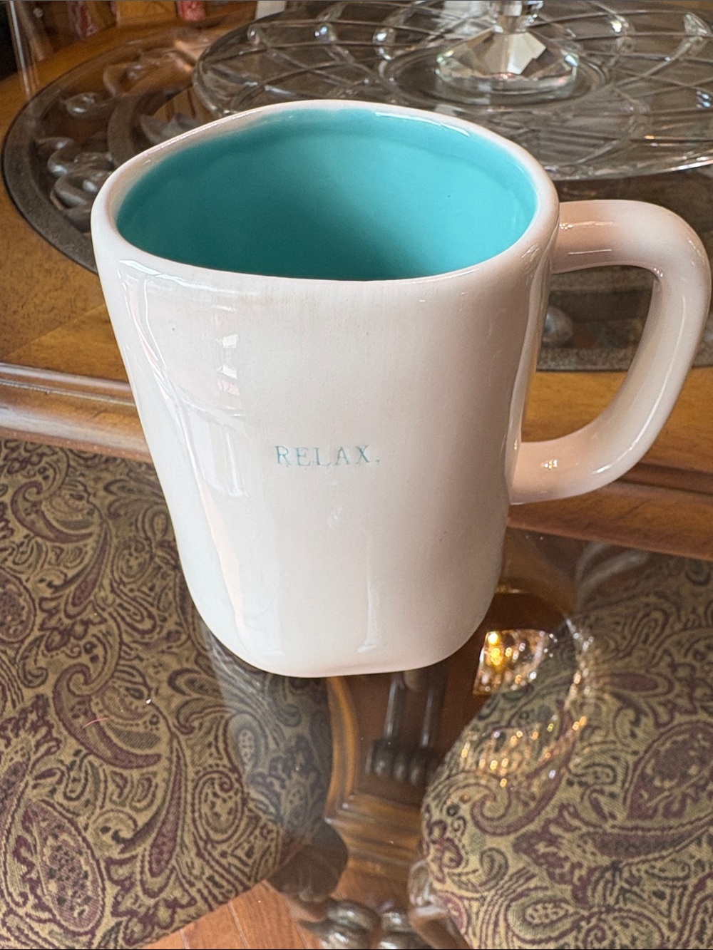 Rae Dunn featuring a bright turquoise interior and small "RELAX" lettering